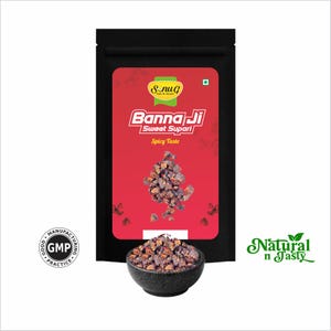 May include: A black package with a red label featuring the text "Banna Ji Sweet Supari Spicy Taste." The image also shows a small black bowl filled with the product and the text "Natural n Tasty."