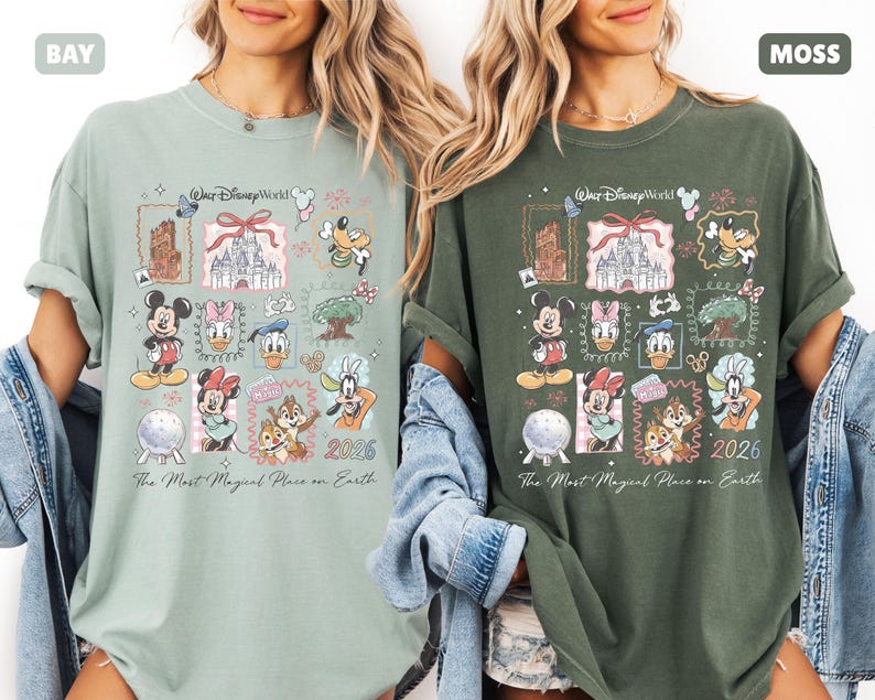 May include: Two t-shirts, one in bay green and the other in moss green, each featuring a colorful Disney World graphic. The design includes various Disney characters, a castle, and the text "The Most Magical Place on Earth" and "2026".