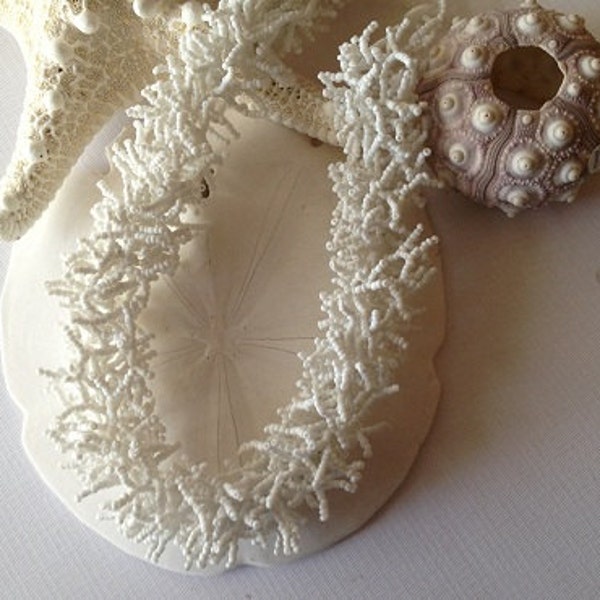 White beaded coral like necklace.