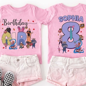 May include: Two pink t-shirts with matching shorts and shoes. One shirt says "Birthday Girl" with cartoon characters. The other shirt says "Sophia" and the number 8. The shorts are light pink, and the shoes are black and white checkered.