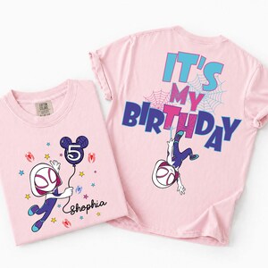 May include: Two light pink t-shirts. One features a cartoon character holding a balloon with the number 5, the name "Shophia", and spider web graphics. The other shirt has the text "IT'S MY BIRTHDAY" and a cartoon character.