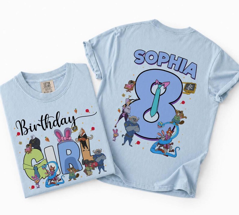 May include: Two light blue t-shirts with cartoon graphics. One shirt says "Birthday Girl" with cartoon characters. The other shirt says "Sophia 8" with cartoon characters. Both shirts are made of cotton.