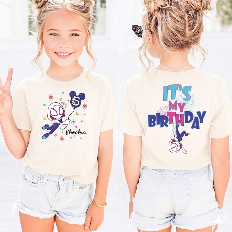 May include: A beige t-shirt featuring a Spider-Gwen graphic holding a Mickey Mouse-shaped balloon with the number 5. The front of the shirt has the name "Shophia" below the graphic. The back of the shirt says "It's My Birthday" with a Spider-Gwen graphic.