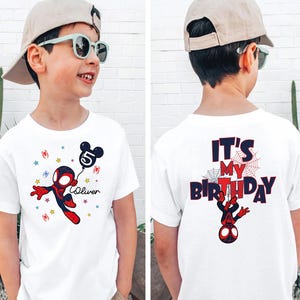 May include: White t-shirt with a Spider-Man cartoon design and a Mickey Mouse balloon with the number 5. The front has the name "Oliver" and stars. The back of the shirt says "It's My Birthday" in red and blue.
