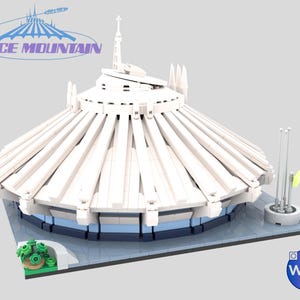 May include: A white and blue model of Space Mountain, a futuristic structure with a conical roof and a central spire. The model includes the text "SPACE MOUNTAIN" in blue and purple. A small green garden is visible on the side.