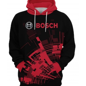 May include: A black hooded sweatshirt featuring a red hood lining and red cuffs. The front displays the Bosch logo in white and silver, accompanied by a red and black geometric abstract pattern that extends across the lower torso and pocket area.