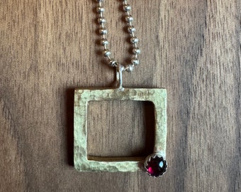 Kaaree Pendant in Brass with Garnet on sterling Silver chain.