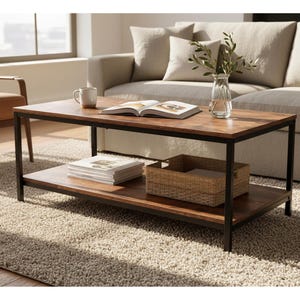 May include: A rectangular coffee table with a dark wood top and lower shelf, supported by a black metal frame. A woven basket, books, and a mug sit on the table. A sofa and chair are in the background.