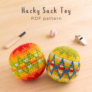 May include: Two round, crocheted hacky sack toys with colorful geometric patterns. One features red, orange, yellow, and green hues, while the other displays green, blue, yellow, and red. Text reads: Hacky Sack Toy PDF pattern.