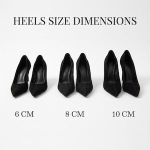 May include: Three pairs of black pointed-toe pumps arranged in a row, labeled HEELS SIZE DIMENSIONS. The pairs are marked with heights of 6 cm, 8 cm, and 10 cm respectively. Each pair features a sleek, solid black finish and a classic stiletto silhouette.