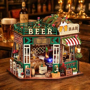 May include: A miniature wooden bar model with a green and brown exterior, featuring the word "BEER" on the roof and "VANCHY TAVERN" on a sign. The model includes a red and white striped awning, a small lamp, and decorative flowers.