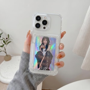 May include: Transparent phone case with a card holder. The case displays a photo of a person holding a drink. The card has the text "Bank Name" and a 16-digit number. The phone has three camera lenses.