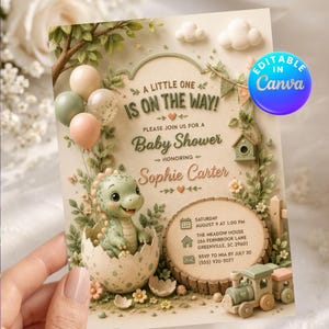 Puede incluir: Una tarjeta de invitación para baby shower con un dinosaurio verde saliendo de un huevo, globos y un tren de madera. El texto dice: A LITTLE ONE IS ON THE WAY! PLEASE JOIN US FOR A Baby Shower HONORING Sophie Carter, SATURDAY AUGUST 9 AT 1:00 PM.