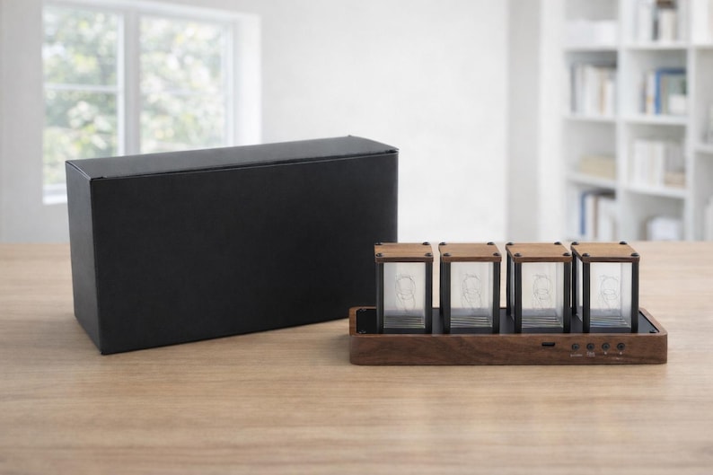 May include: A modern digital clock with four glass tubes and wooden accents. The clock sits on a wooden base with buttons and is next to a black box. The clock's design is minimalist and contemporary.