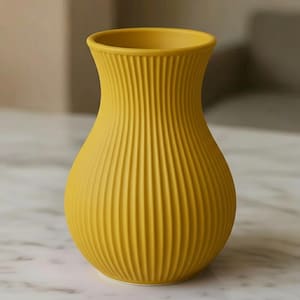 Può includere: Un vaso in ceramica giallo senape con un design verticale a coste. Il vaso ha un corpo arrotondato e un'apertura svasata. Il colore è un giallo brillante e solare e il vaso viene probabilmente utilizzato per esporre fiori o come oggetto decorativo.