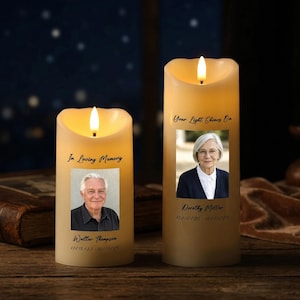 Puede incluir: Dos velas LED de color marfil con llamas parpadeantes. Cada vela presenta una fotografía enmarcada y texto. Una dice "In Loving Memory" y "Walter Thompson 11/10/33 - 10/11/25." La otra dice "Your Light Shines On" y "Dorothy Miller 11/10/35 - 10/11/25."
