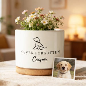 May include: A trio of cream-glazed ceramic mugs, each adorned with a hand-painted floral pattern in blue, green, and yellow. The mugs have a rounded form and a handle for easy grip. The speckled glaze adds a rustic touch.