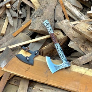 May include: A set of three ceramic mugs with a speckled, matte finish. The mugs are in shades of cream, light gray, and dark gray. Each mug has a simple, minimalist design and a rounded handle.