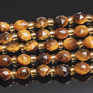 May include: A strand of faceted tiger's eye beads with gold spacers. The beads are a rich brown color with a golden sheen.