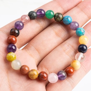 May include: A colorful beaded bracelet with various gemstones, including amethyst, turquoise, and green aventurine.