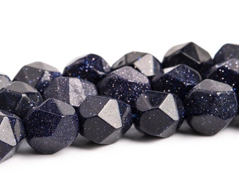 Pode incluir: Um fio de contas de pedra preciosa facetadas de cor azul escuro com um acabamento brilhante. As contas são todas do mesmo tamanho e forma, e são enfiadas em um fio transparente.