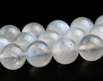 May include: A strand of white moonstone beads, each bead is smooth and round, with a slight iridescent sheen.
