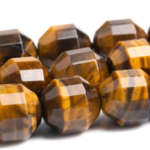 May include: A strand of faceted tiger's eye beads in shades of brown and gold. The beads are round and have a polished finish.