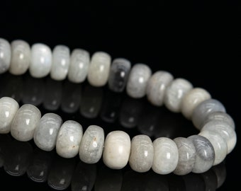 May include: A strand of white and gray moonstone beads, strung together to form a bracelet. The beads are round and have a smooth, polished finish.