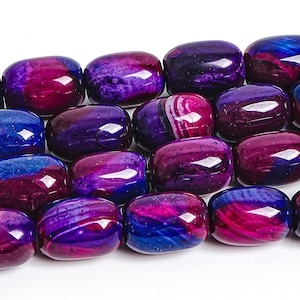 May include: Close-up of a strand of polished, oval-shaped beads. The beads display a mix of colors, including deep purple, magenta, and blue, with a glossy finish. Some beads have a striped pattern. The beads are likely for jewelry making.