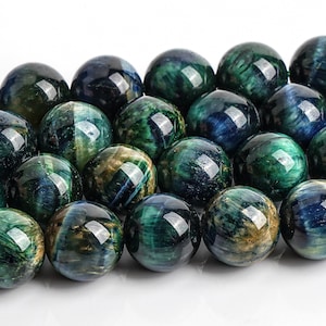 May include: A strand of round, green and blue tiger's eye beads. The beads have a shimmering, iridescent effect.