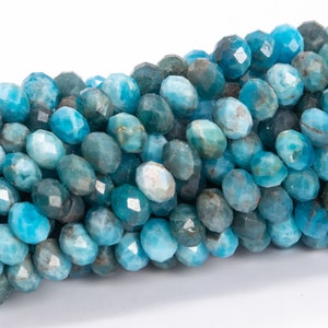 May include: A strand of faceted blue apatite beads. The beads are a light blue color with a slightly cloudy appearance. The beads are all approximately the same size and shape.