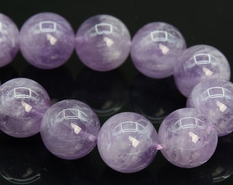 May include: A strand of amethyst beads, each bead is a deep purple color with a slight shimmer. The beads are round and smooth, and they are strung together on a clear elastic cord.