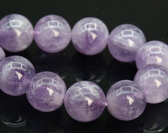 May include: A strand of round, purple amethyst beads. The beads are smooth and polished, with a slight sheen.