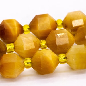 May include: A strand of faceted golden tiger's eye beads with yellow spacer beads.