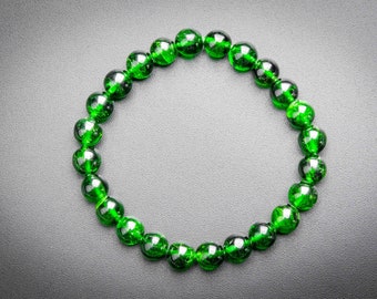 Puede incluir: Un brazalete de piedras preciosas verdes con cuentas redondas.
