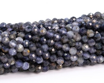 May include: A strand of faceted blue kyanite beads. The beads are round and have a slightly metallic sheen.