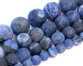 May include: A strand of blue and gray gemstone beads. The beads are round and have a smooth, polished finish.