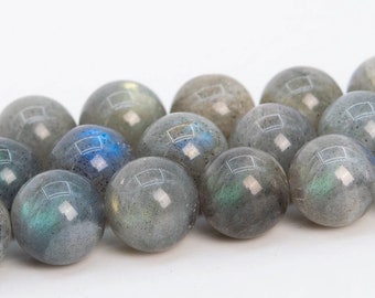 May include: A strand of round, gray labradorite beads with iridescent blue and green flashes. The beads are smooth and polished.