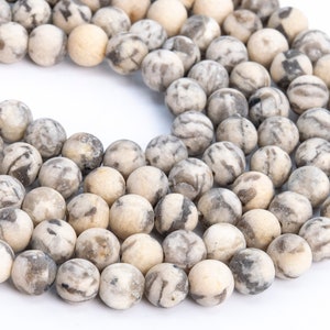 May include: A strand of round, white and gray agate beads. The beads have a marbled pattern and are approximately 8mm in diameter.