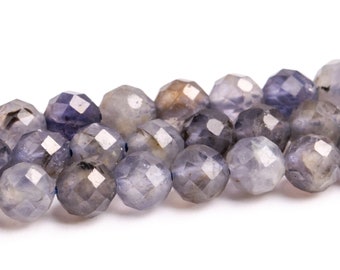 May include: A strand of faceted gemstone beads in shades of gray and purple. The beads are round and have a smooth, polished finish.
