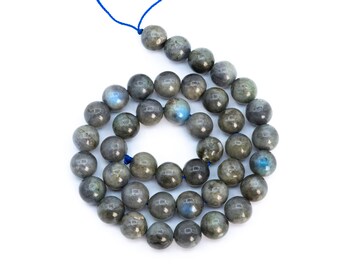 May include: A strand of gray labradorite gemstone beads with a blue cord. The beads are round and have a smooth, polished finish.