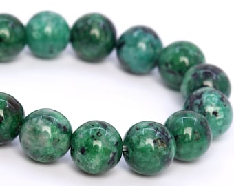May include: A green gemstone bracelet with round beads. The beads have a mottled green and black pattern.