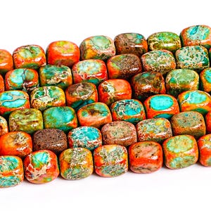 May include: A strand of colorful, multi-faceted, square-shaped gemstone beads. The beads are a mix of orange, brown, green, and turquoise.