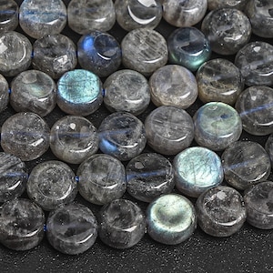 May include: A strand of round, gray labradorite gemstone beads with iridescent blue and green flashes. The beads are smooth and polished.