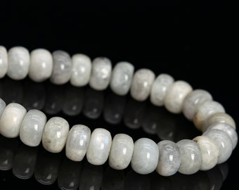 May include: A white gemstone bracelet with round beads. The bracelet is made of natural moonstone beads.