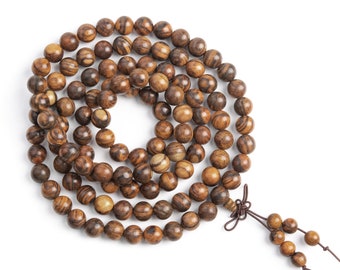 May include: A brown wooden beaded necklace with a dark brown tassel. The beads are round and have a natural wood grain pattern.