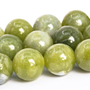 May include: A strand of round, green jade beads. The beads are smooth and polished, with a slight sheen.