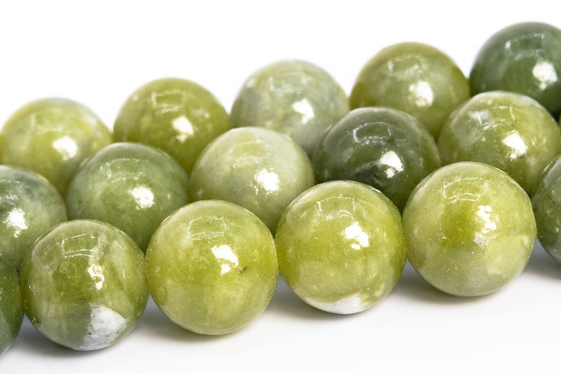 May include: A strand of round, green jade beads. The beads are smooth and polished, with a slight sheen.