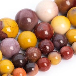 May include: A strand of colorful gemstone beads, featuring shades of brown, yellow, and purple. The beads are round and smooth, with a polished finish.