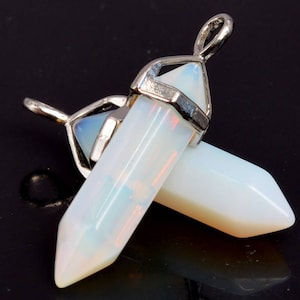 May include: Two white opal crystal point pendants with silver tone metal settings. The pendants are attached to a silver tone chain.